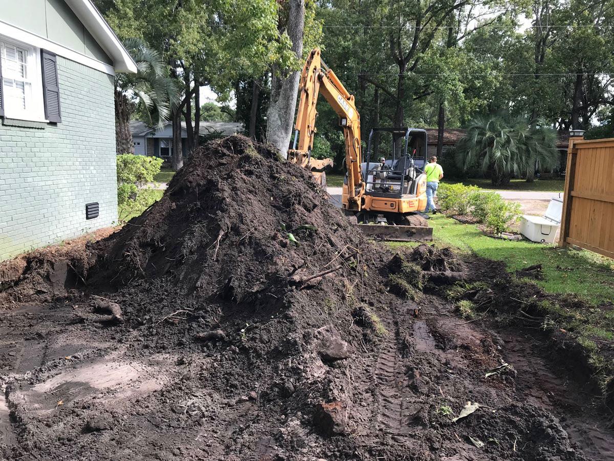 Machinery moving earth to clear the footprint for future owner suite addition.