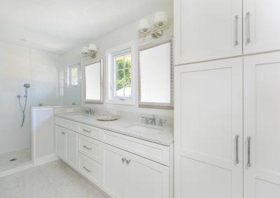 Master bathroom with dual vanity, streamlined and classic cabinetry and walk-in shower.