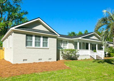 Master suite addition on off-white painted brick home.