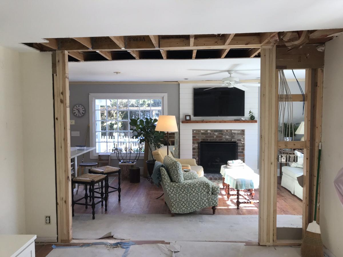 Interior renovation and addition looking through newly framed doorway looking into the current living space.