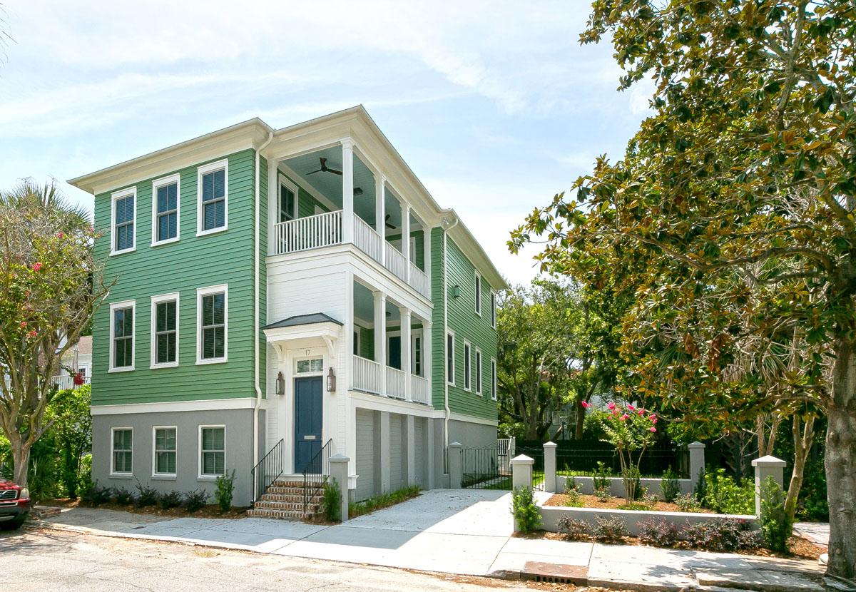 Charleston row house historical renovation with beautiful siding, porches, entry and landscaping.