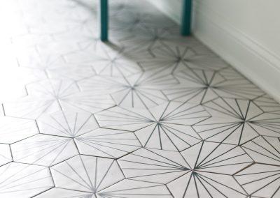 Hexagonal tile floor with decorative design creating a custom visual accent.