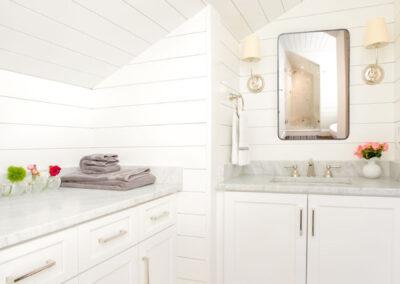 Bathroom with alcove sink, shiplap walls and ceiling and beautiful wood floors.