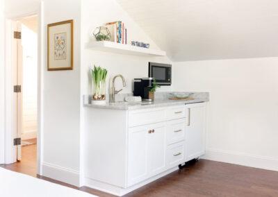 Inlaw suite kitchen with hidden mini fridge, hand sink, microwave and cabinet