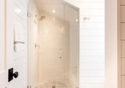Full bath view of custom shower and shiplap walls and ceiling.
