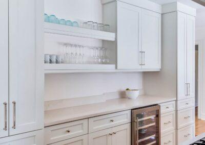 Another angle of custom cabinets, open shelving and wine fridge.