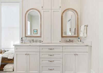 Double vanity in master bath with custom cabinets and unique mirrors.