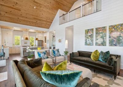 Looking inward and up from living room, dining, kitchen combo to loft and upper level.