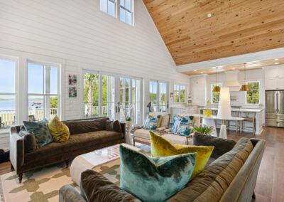 Scenic view from inside living room, dining, kitchen combo - out large windows and sliding doors from eclectic modern and coastal classic comfort.