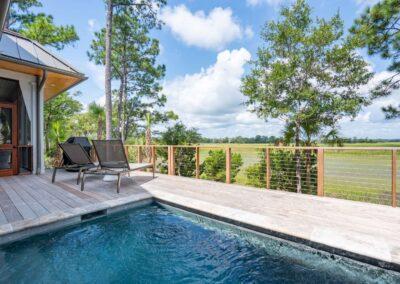 Pool and deck view looking over the expansive marsh in the background.