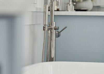Blurred persepctive looking into a bathroom with beautiful hardware and a tub.