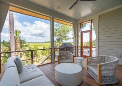 Screened porch overlooking the open air porch with grill and steps down to lower level.