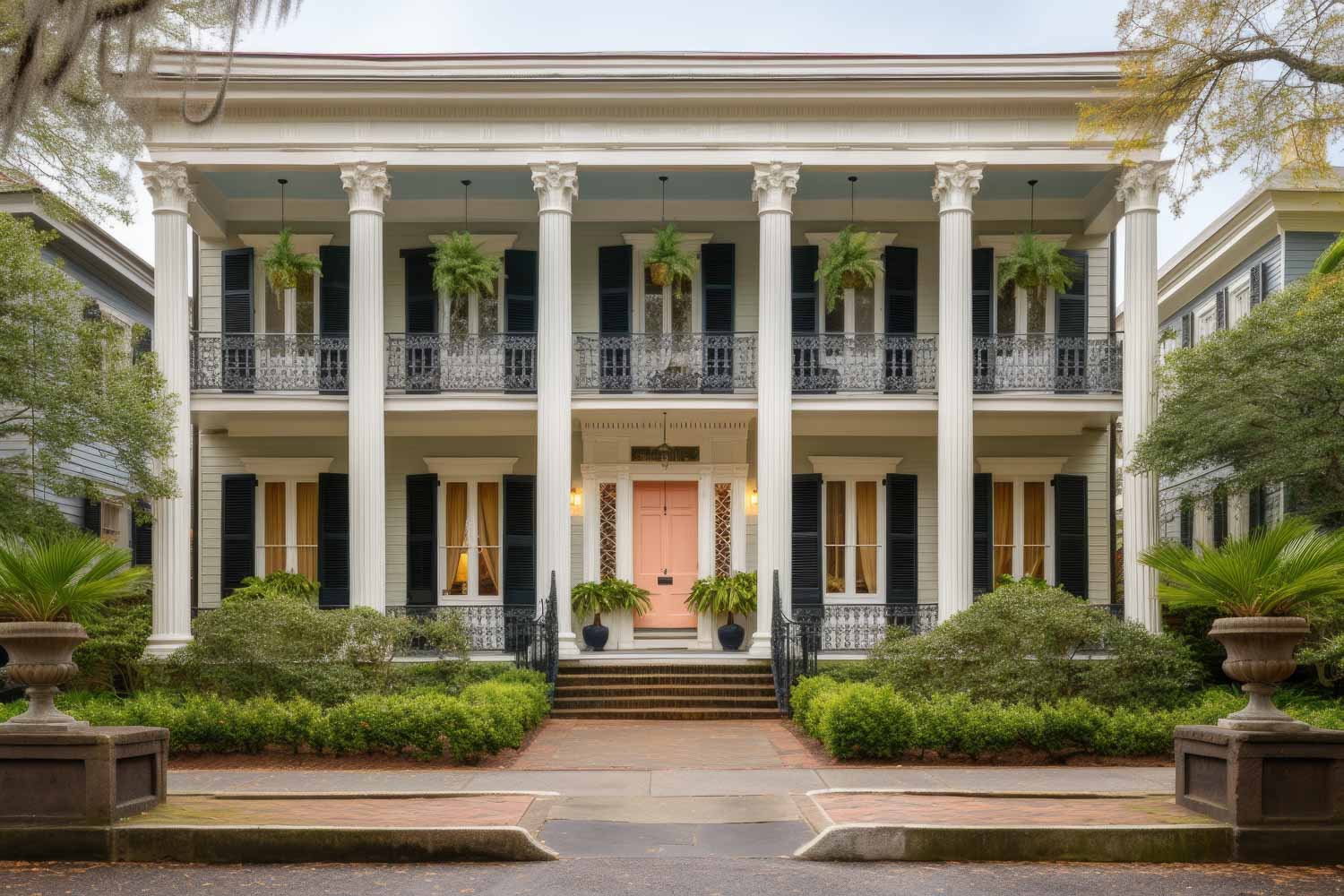 Exterior shot of a Kiawah Island custom home from street level. Home is 4 stories and lit at dusk with landscaping and landscape lighting. Built by Charleston's 5-Star Home Builder Reviews, Stono Construction.